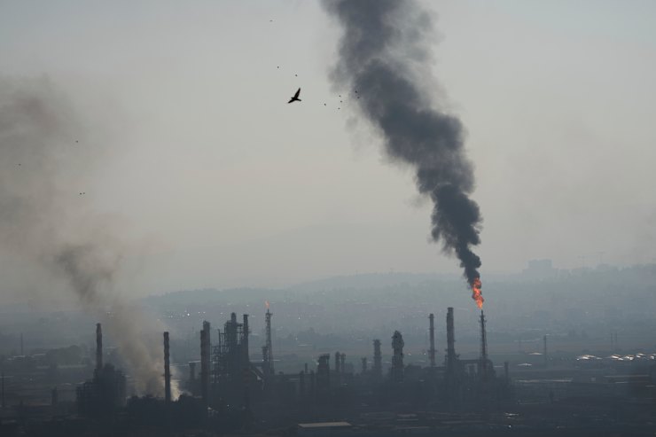 Smoke rises from an oil refinery in Haifa after being struck by an Iranian missile.