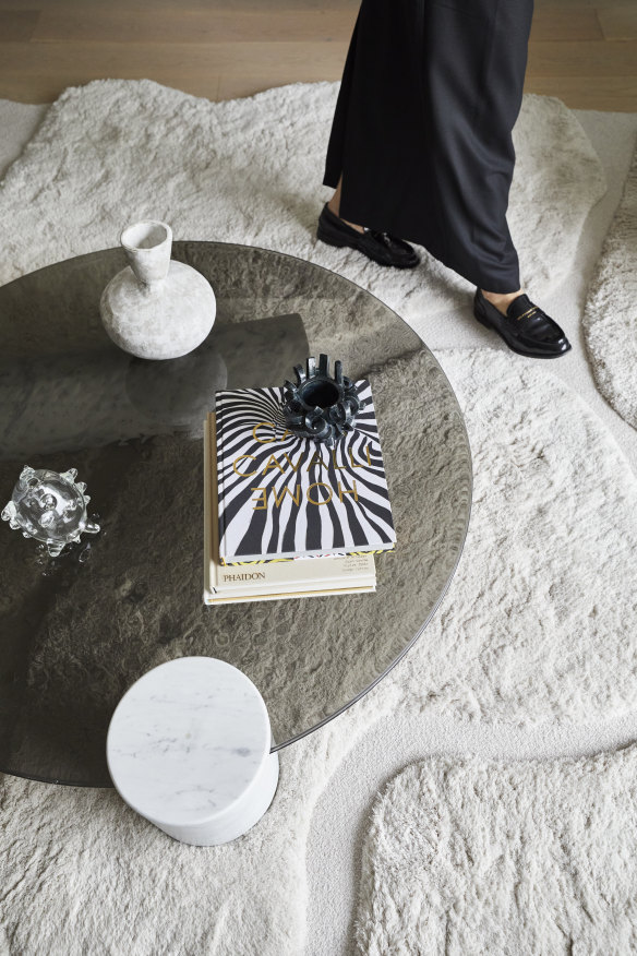 A marble and glass Verre Particulier coffee table by Studiopepe is from Space Furniture and 
sits on a custom “Island” rug by Jov, from Halcyon Lake. The vase is by Heather Rosenman.