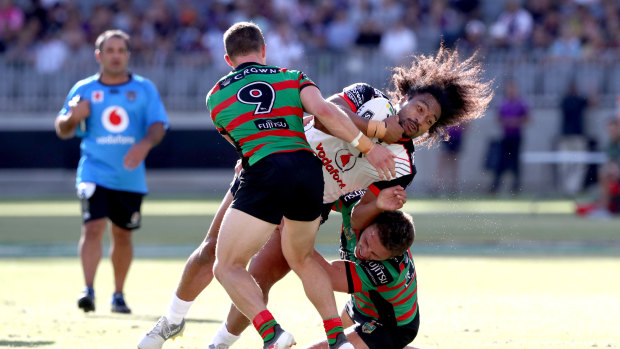 Hard yakka: Damien Cook and Sam Burgess take on defensive duties in the Perth heat.