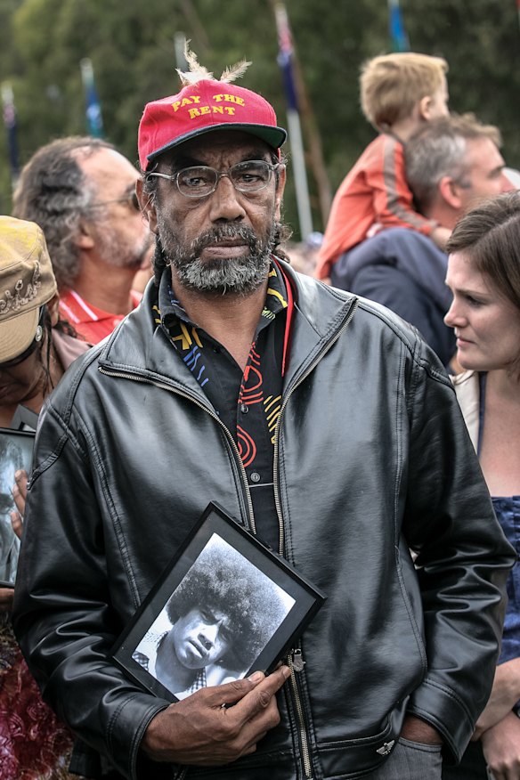 Mick Edwards on the day of the apology with a picture of his deceased brother, Wally.