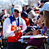Lachie Neale signs autographs for fans after the grand final.