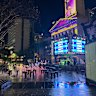 Puddles around a Magic Round activation in King George Square on Thursday night.