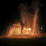 A fire dancer performs during a show for tourists on Batu Ferringhi Beach on Penang Island, Malaysia.