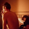 Nan and Brian in bed, NYC 1983, by Nan Goldin