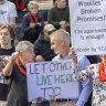 An anti-Woolworths development demonstrator confronts a YIMBY heckler at a community rally in Elsternwick.