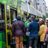 Passengers waiting to board a packed tram in the free zone on Friday.