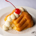 Le Foote’s rum baba with sabayon and maraschino cherry.