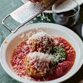 A dollop of basil pesto adds piquancy to this classic meatball dish.