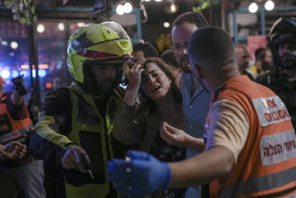 A woman reacts at the scene of a shooting attack In Tel Aviv, Israel, on  April 7.