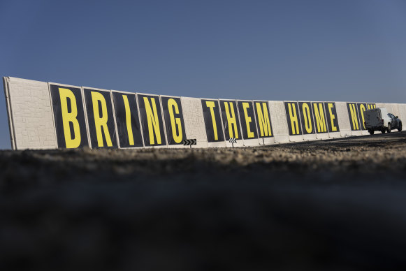 An Israeli military car drives past a protective wall near the border with Gaza Strip on Monday.