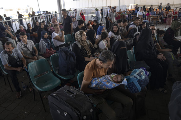 Families waiting to cross into Egypt at the Rafah crossing.