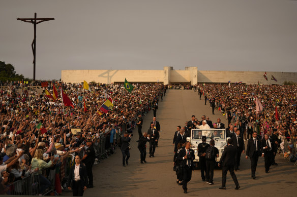 Francis arrives surrounded by bodyguards at Our Lady of Fatima shrine in Fatima, central Portugal on Saturday.
