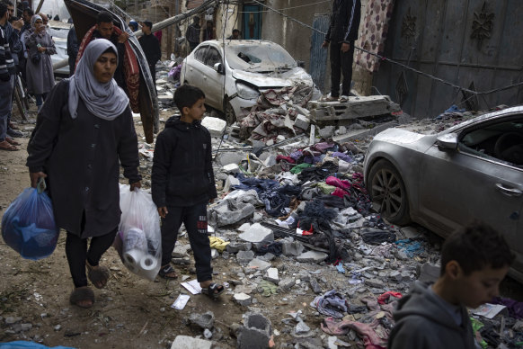 Palestinians look at the destruction after an Israeli airstrike in Rafah.