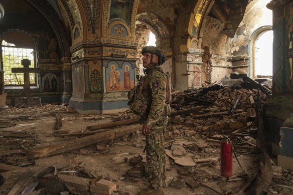 Ukrainian serviceman Gennadiy Yudin stands inside of an orthodox church heavily damaged by a Russian bombing in Novoekonomichne, Ukraine on Tuesday.