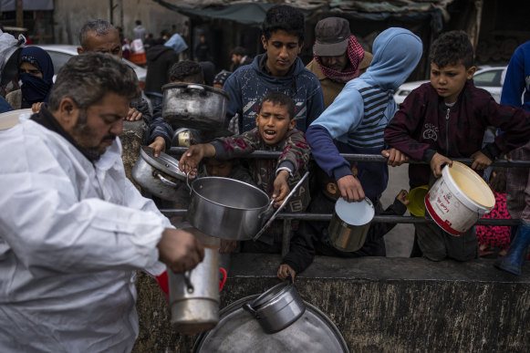 Palestinians line up for food in Rafah, Gaza Strip, last month.