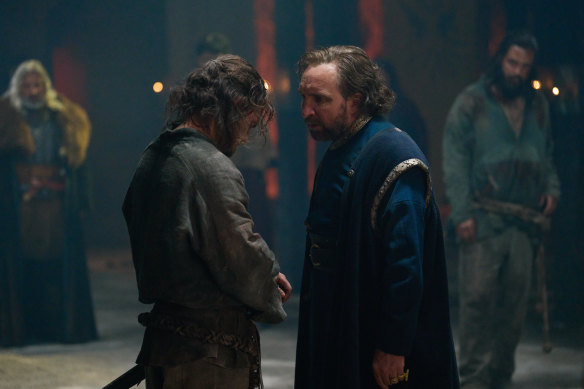 The young Arthur (Iain De Caestecker) and High King Uther (Eddie Marsan) in The Winter King (2023).