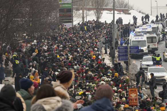 Police (at right) observe as people walk towards the Borisovskoye Cemetery for Alexei Navalny’s funeral ceremony in Moscow.