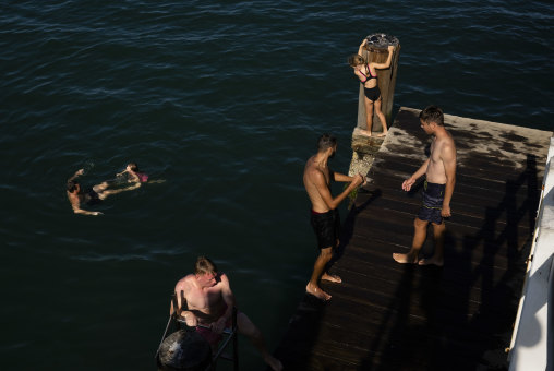 Swimmers enjoy one of the last dips of summer off the Coffs Harbour jetty in February.