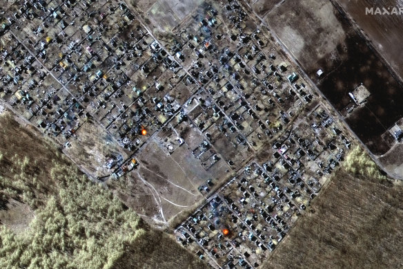 This multispectral satellite image provided by Maxar Technologies shows destroyed homes, impact craters and fires in town of Moschun, Ukraine on Friday, March 11, Ukraine time. 