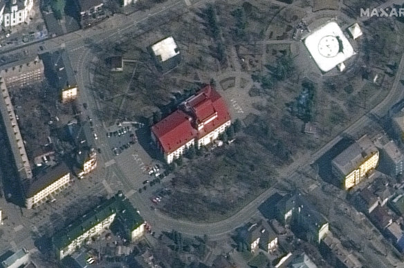 The Mariupol Drama Theatre in Mariupol, Ukraine, on Monday, with the word “children” painted on the ground at the front and back of the building.