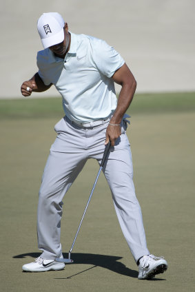 Back at it: Tiger Woods celebrates a birdie putt on the 18th green during the third round of the Arnold Palmer Invitational golf tournament.