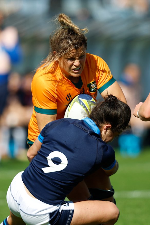 Get out of my way ... Hamilton sits down a Scottish defender.