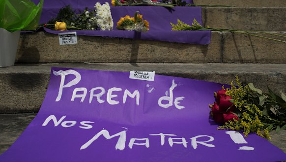 A sign with a message that reads in Portuguese: "Stop Killing Us!" makes up part of a makeshift memorial for Franco.