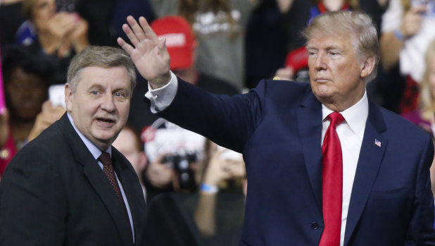 President Donald Trump, acknowledges the crowd during a campaign rally with Republican Rick Saccone.