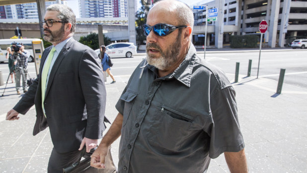 Andre-Shane Moorby (right) arrives at Roma Street Magistrates Court,.