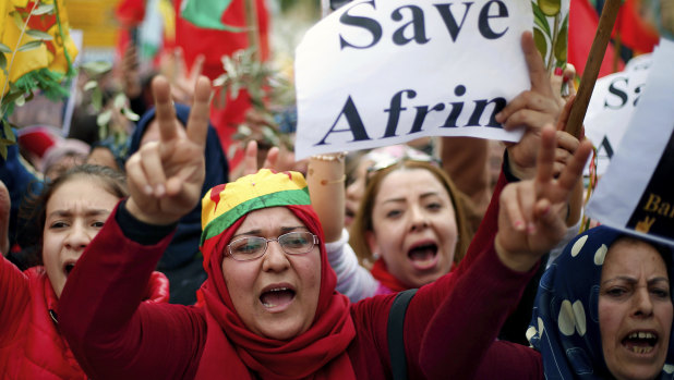 Kurdish demonstrators chant slogans as they flash victory signs during a protest against the operation by the Turkish army aimed at ousting the US-backed Kurdish militia from the area in Afrin, Syria.