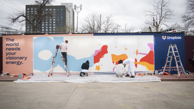 Artists work on a live mural titled 'Activism Through Art'  during the South By Southwest (SXSW) conference on Friday.
