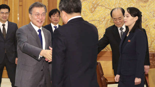 South Korean President Moon Jae-in (left) shakes hands with North Korean official Ri Son-gwon as Kim Jong-un's sister Kim Yo-jong (right) looks on at a February meeting. The two Koreas have held unprecedented diplomatic talks. 