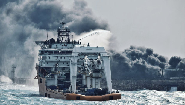 In a photo dated 10 January 2018, China's Ministry of Transport, a firefighting boat works to put on a blaze on the oil tanker Sanchi in the East China Sea off the eastern coast of China. 