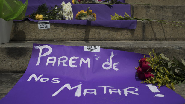 A sign with a message that reads in Portuguese: "Stop Killing Us!" makes up part of a makeshift memorial for Franco.