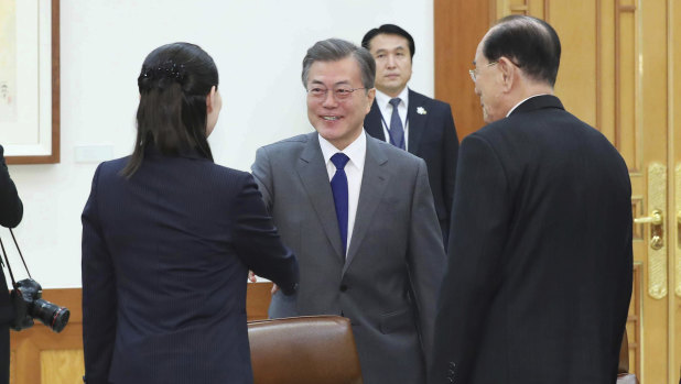South Korean President Moon Jae-in, center, shakes hands with Kim Yo Jong,  left, sister of North Korean leader Kim Jong Un.