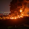 Fire and smoke rise into the sky after an Israeli attack on the Shahran oil depot in Tehran.