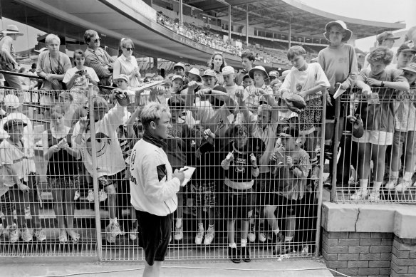 Shane Warne signs autographs during Victoria’s Sheffield Shield match against New South Wales at the SCG in December 1993.