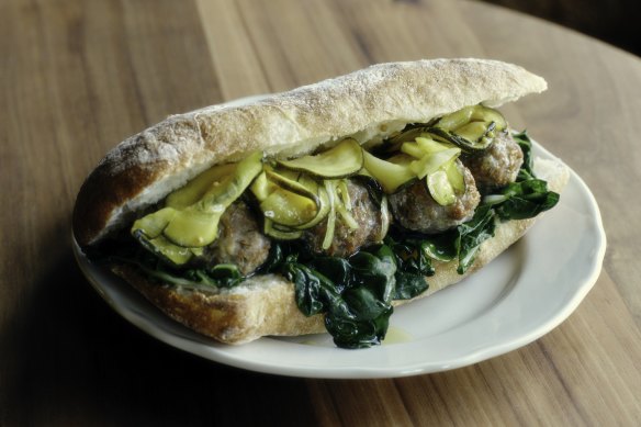 Pork and fennel meatball sandwich with garlic aioli, chard, and B&amp;B pickles.