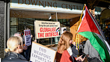 Protesters hold placards outside the Downing Centre earlier this month.