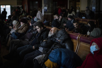 People trying to flee Ukraine sleep inside a crowded Lviv railway station on Monday, February 28, as Russia’s military assault entered its fifth day.