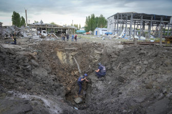 Police members inspect a crater caused by a Russian rocket attack in Pokrovsk, Donetsk region, Ukraine, on Wednesday.