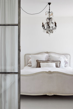 Steel-framed glass doors replaced a wall between the sitting room and bedroom. 