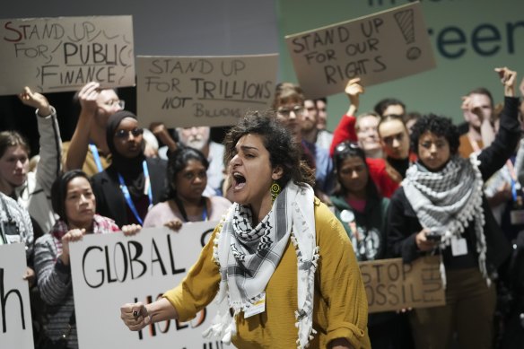 Activists participate in a demonstration for climate finance at the COP29 UN Climate Summit.