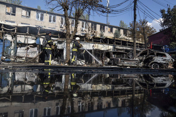 Rescue workers puts out a fire after a Russian rocket attack on a food market in the city centre of Kostiantynivka, Ukraine.