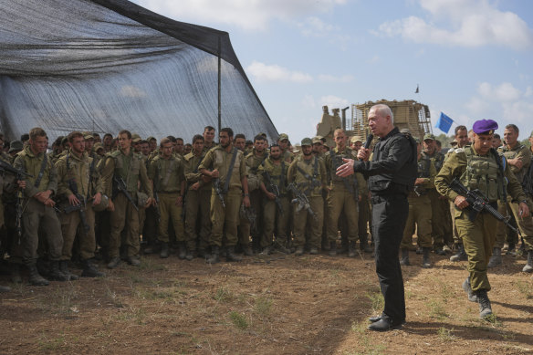 Israeli Defence Minister Yoav Gallant speaks to Israeli soldiers in a staging area near the border with Gaza.