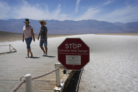 A sign warns visitors of extreme heat danger at Badwater Basin, in Death Valley National Park.