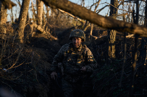 An infantry soldier takes cover from enemy fire near Vuhledar at dawn  near Vuhledar, Ukraine. 