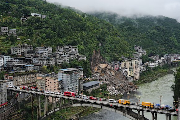 Rescuers conduct a search and rescue operation at the scene of a landslide in Chongqing province in mid-July.