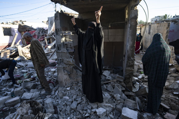 Palestinians inspect destruction after an Israeli strike in Rafah, southern Gaza, on January 18.