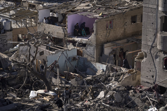Palestinians look at the destruction after an Israeli strike on residential buildings and a mosque in Rafah, Gaza Strip.